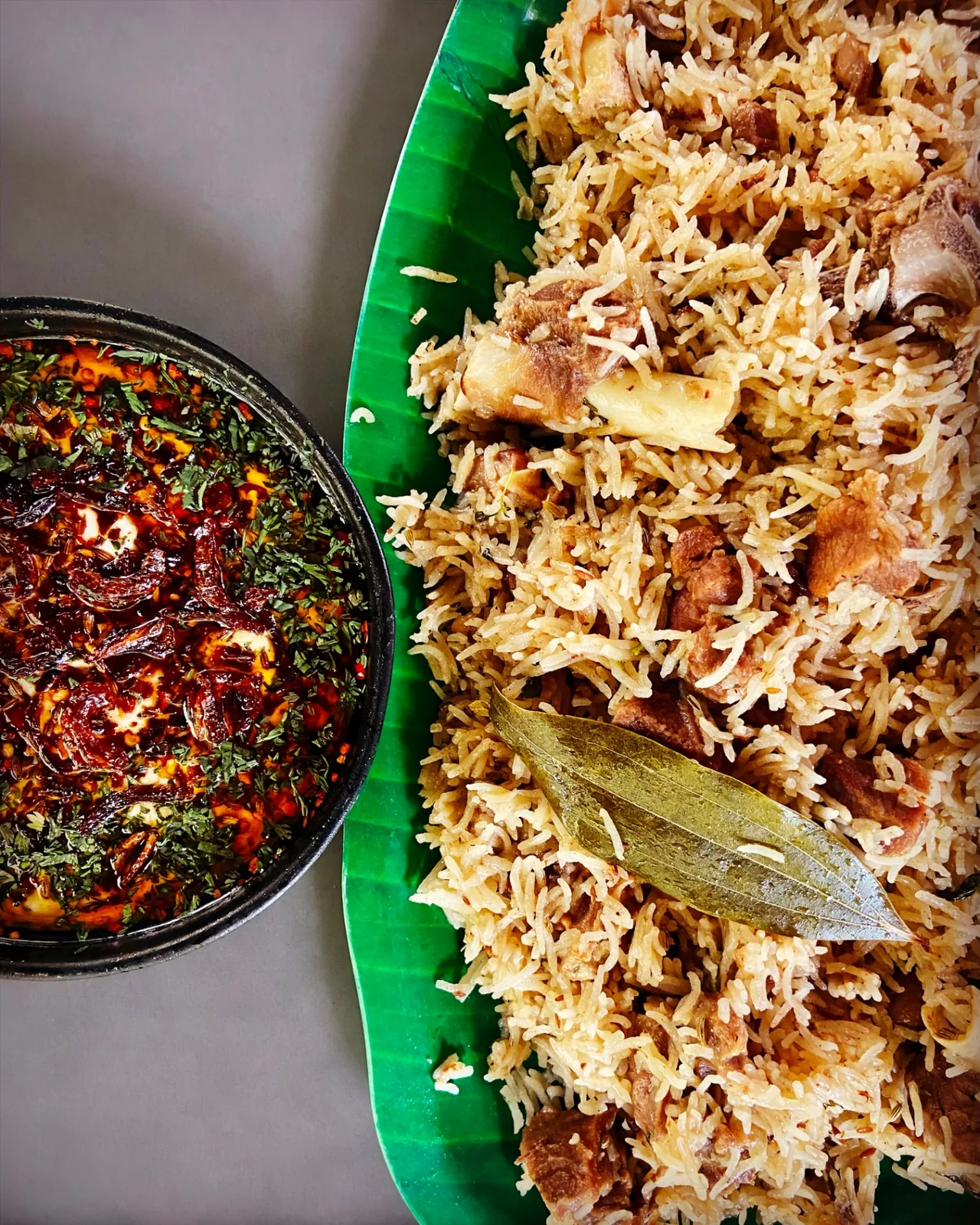 Mutton biryani on banana leaf with chutney